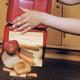 Boy spilling contents of lunch box onto ground